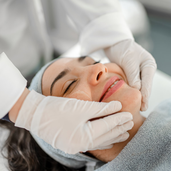 woman at bliss lab getting facial treatment