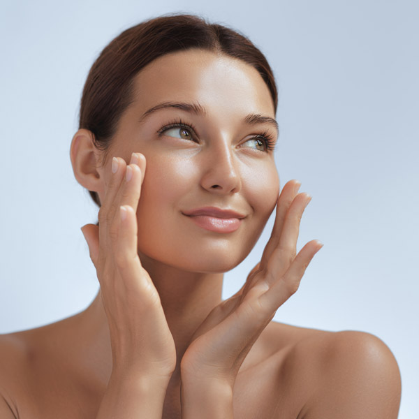 woman with beautiful skin touching the sides of her face