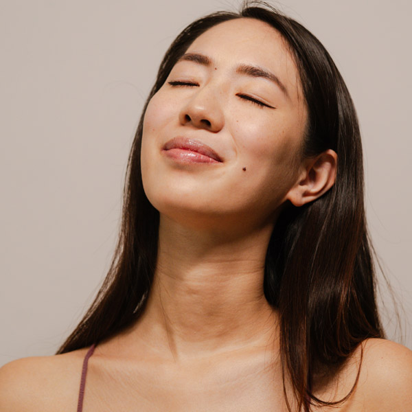 close up of woman smiling with beautiful skin